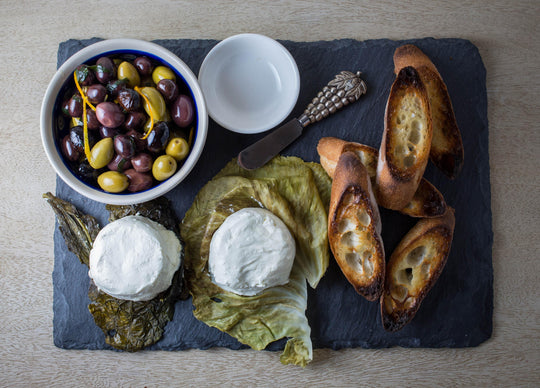 leaf wrapped goat cheese with olives and toast